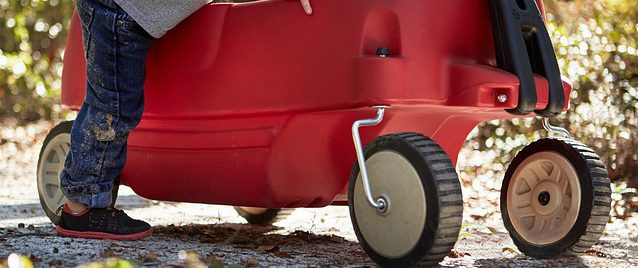 A mother was charged with Child Abuse after towing her children in a red plastic wagon behind her car on a public road.